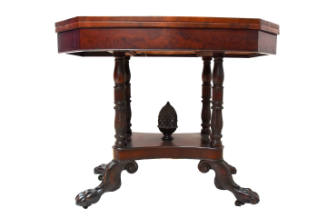 A mahogany card table with four carved columns, a carved pineapple and acanthus-carved hairy ho…