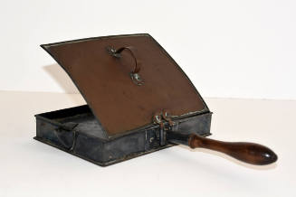A rectangular toaster pan with a wooden handle.