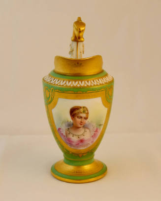 A green porcelain cream pitcher with a gold framed portrait of a noble woman on the body, a gol…