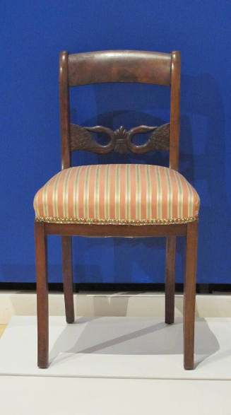 One of a pair of side chairs featuring swan neck back splats and striped cushions.