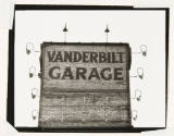 A black and white photograph of a brick façade with the words “Vanderbilt Garage.”