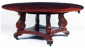 Circular dining table with demi-lune extensions raised on four S-scroll carved uprights, restin…