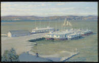 A view of a harbor with several docked ice boats and a sailboat in the background.

