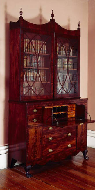 A mahogany secretary with two glass cupboard doors opening to an interior with adjustable shelv…