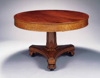 A round mahogany table with a hexagonal pedestal with a carved foliate motif and a tripod base …