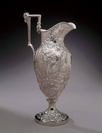 An oviform water pitcher embossed and chased with flowers and ferns on a matted ground with an …