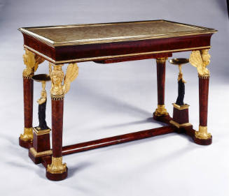 A wooden library table with a brass mounted marble top, winged bust bronze dore legs, and a str…