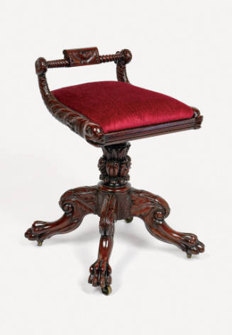 A mahogany piano stool with swiveling slip seat, rails in the form of two dolphins connected by…