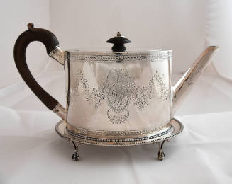 A silver oval, straight-sided teapot with a wooden handle and finial on the lid, and adorned wi…