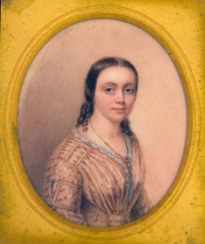 A miniature watercolor portrait of a young woman in a pink dress lined with white ruffles and w…