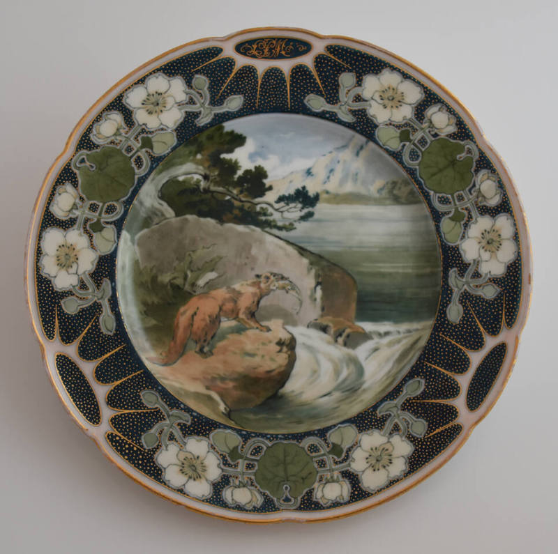 The second plate features a blue rim with three clusters of white flowers and green leaves alte…
