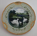 The seventh plate features a green rim with three clusters of long white leaves alternating wit…