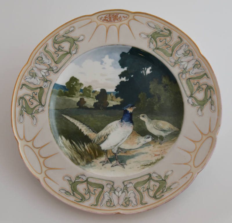 The ninth plate features a white rim with three clusters of white flowers with long green leave…
