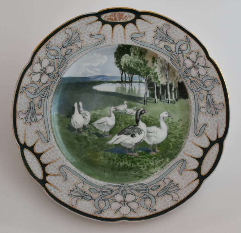 The tenth plate features a pale pink rim with three clusters of pink flowers with long blue lea…