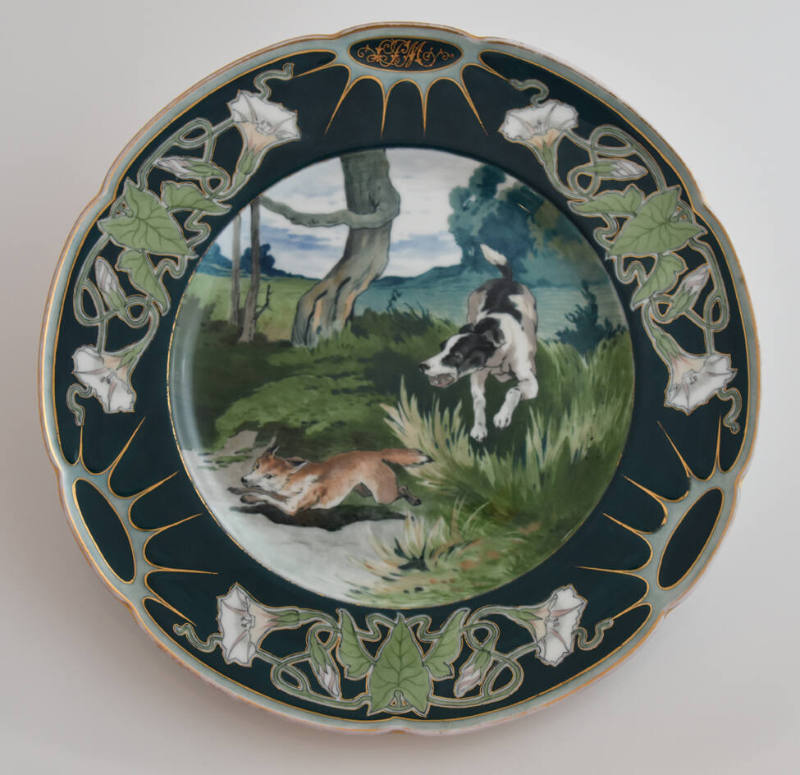 The eleventh plate features a blue rim with three clusters of white flowers and green leaves al…