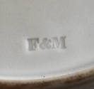 A detail of the maker's mark impressed on the bottom of the twelfth plate in the set. This part…