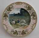 The thirteenth plate features a pink and green rim with three clusters of white flowers with br…