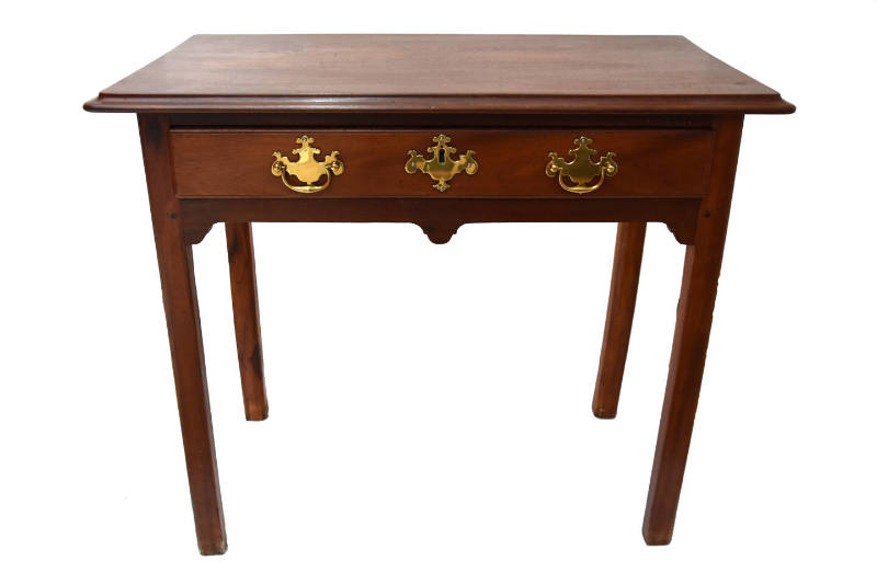 A mahogany straight-legged dressing or side table with single drawer featuring three brass escu…