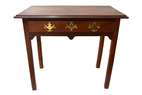 A mahogany straight-legged dressing or side table with single drawer featuring three brass escu…