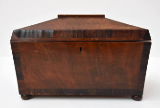 A lockable pine and rosewood tea caddy with two compartments on the interior with ivory knobs.