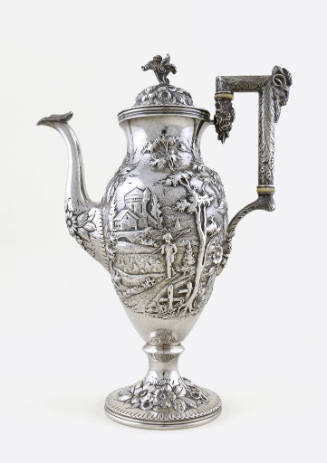 A silver teapot embellished with a repousse alpine scene on an urn-shaped body mounted atop a f…
