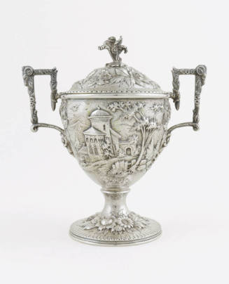 A silver sugar bowl embellished with a repousse alpine scene on the body mounted atop a floral …
