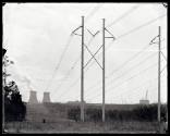 Powerlines recede to a powerplant in the background.