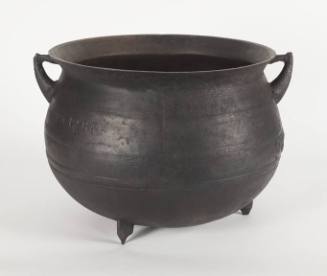 12-gallon cast iron pot on three legs with two handles.