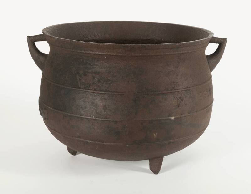 8-gallon cast iron pot on three legs with two handles.