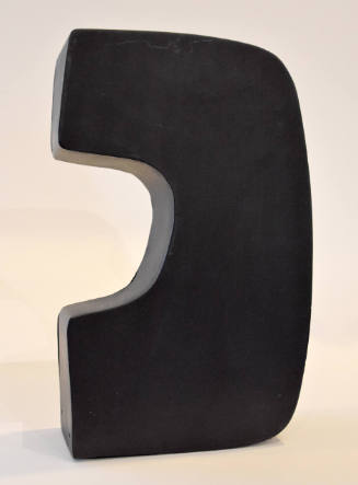An aluminum sculpture painted black. Its curvilinear shape somewhat resembles the letter "C."