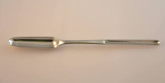 A slender silver scoop. 