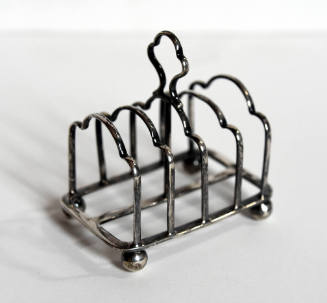Silver toast rack for four pieces of toast.