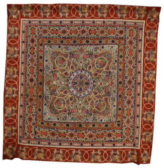 A vibrantly colored and heavily embroidered red wool bed cover with silk embroidery.