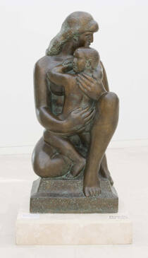A bronze sculpture of a nude woman sitting on one leg with the other leg bent at the knee holdi…