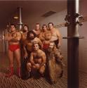 A group of wrestlers standing in a shower.