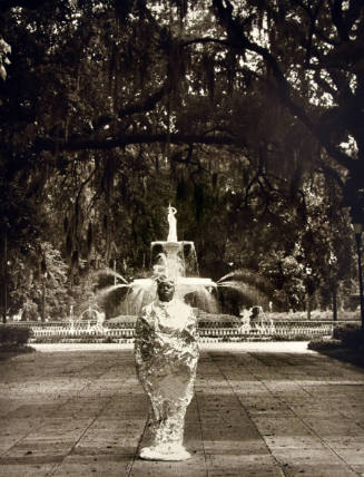 A woman wrapped in foil standing in front of the fountain in Forsyth Park.