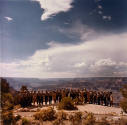 A group of park rangers standing by a cliff edge overlooking the canyon. 