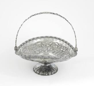 A silver swing-handled cake basket on a fluted and engraved stand, with repousse foliage, and a…