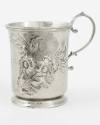 Christening cup adorned with a single handle and a wreath of repoussé foliates containing the i…