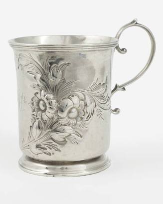 Christening cup adorned with a single handle and a wreath of repoussé foliates containing the i…