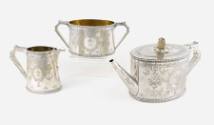 A Victorian three-piece tea service with finely engraved cartouches depicting a heraldic cross,…