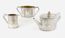 A Victorian three-piece tea service with finely engraved cartouches depicting a heraldic cross,…