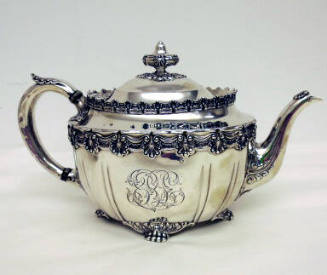 A sterling silver teapot with four clawed-feet and floral gadrooning around the waist and edge …