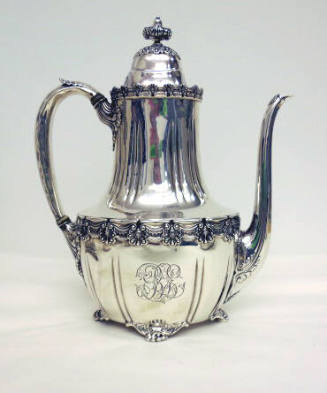 A sterling silver coffeepot with four clawed-feet and floral gadrooning around the waist and ed…