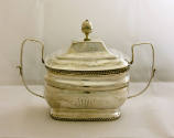 A two-handled sugar bowl with a gadrooned footed base, gadrooned rim and accompanied by a remov…
