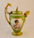 A green porcelain coffeepot with a gold framed portrait of Caroline Bonaparte on the body, gold…