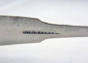 Maker's mark stamped on the interior of the arm. 