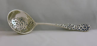 A silver sugar sifter in the Rococo pattern. 
