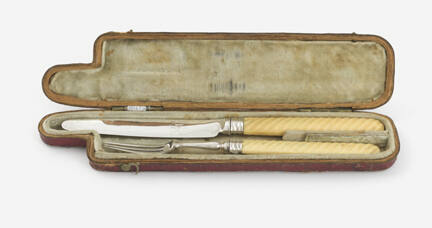 Silver knife and fork with ivory handles in original red case with silk lining.