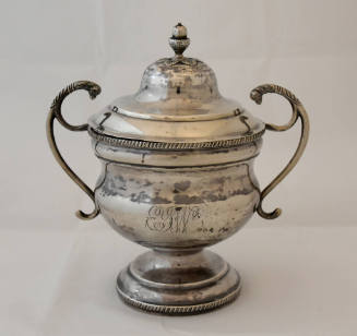 A sugar bowl with a waisted body on a circular stepped pedestal with S-scroll handles terminati…